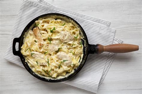 Homemade Chicken Fettuccine Alfredo In A Cast Iron Pan On A White