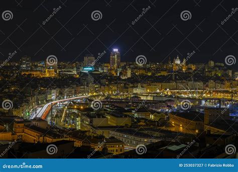 Panoramic View Of Genoa At Night With The Causeway And The Buidings Of