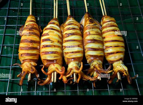 Grilled squid skewers, Naka Weekend Market, Phuket, Thailand Stock Photo - Alamy