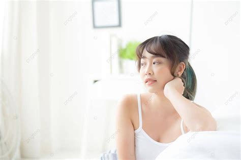 Beautiful Asian Woman Wakes Up Glowing On Bed Photo Background And