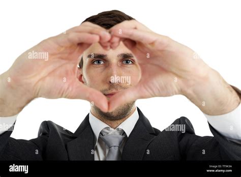 Smiling Attractive Young Man Makes The Heart Using Fingers Stock Photo