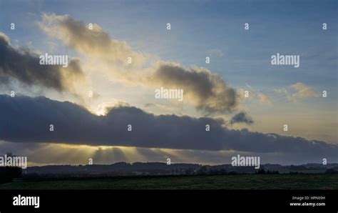 Rays of light shine through clouds Stock Photo - Alamy