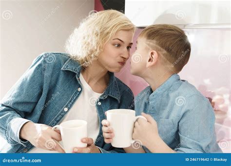 Mother And Her Cute Son Are Drinking Tea And Making Silly Faces Stock