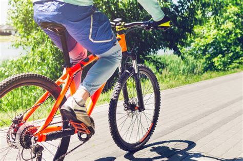 Cyclist on an Orange Bike Riding a Bicycle Path Stock Image - Image of ...