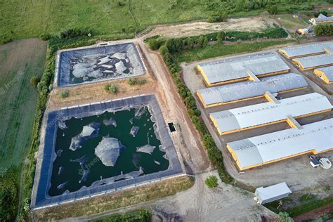 Premium Photo Aerial View Of Cattle Farm Buildings Between Green