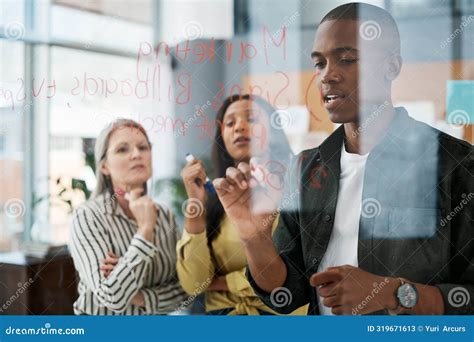 Business People Thinking And Writing On Glass With Teamwork