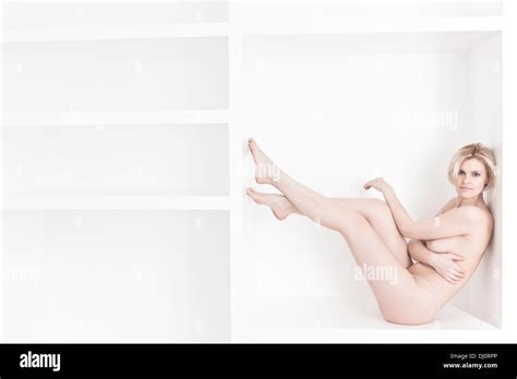 Naked Woman Sitting In The Wardrobe Stock Photo Alamy