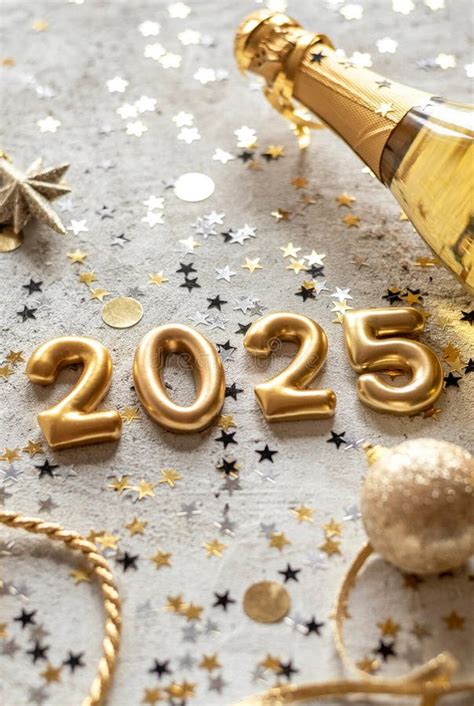 Golden 2025 New Year Numbers With Confetti And Champagne Bottle Stock