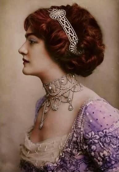 An Old Fashion Photo Of A Woman With Red Hair Wearing A Tiara And Necklace