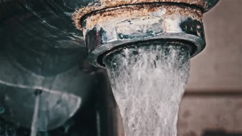 Water Flows From An Old Contaminated Tap With Calcium And Grime Into A