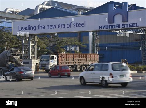 Cars Pass A Factory Of Hyundai Steel Just Opposite The Large South