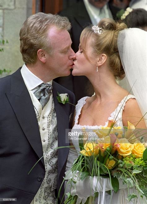 Comedian Les Dennis with his bride, actress Amanda Holden, following their wedding in ...