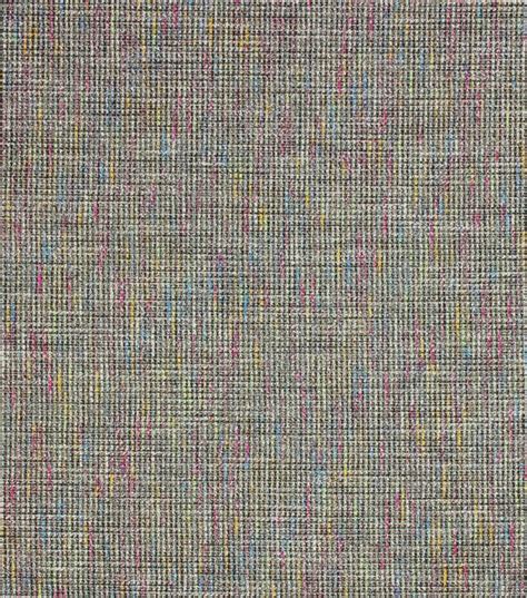 An Upholstered Fabric Textured With Multicolored Lines And Dots In