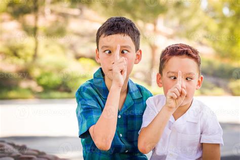 Outdoor Portrait Of Biracial Chinese And Caucasian Brothers Having Fun