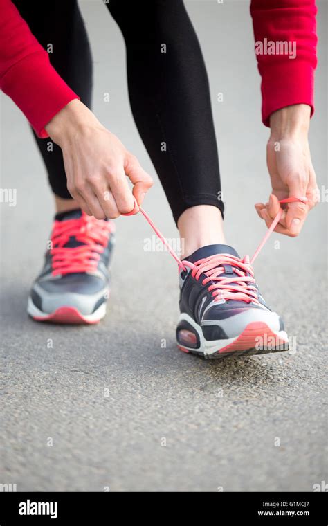 Sporty Woman Tying Shoelace On Sneakers Before Training Female Athlete