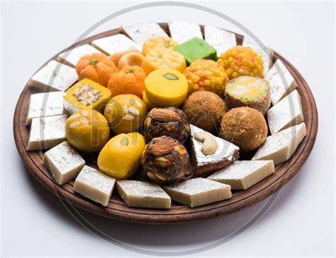 Image Of Indian Sweets Served In Silver Or Wooden Plate Variety Of