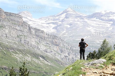 A Woman Staring At The Monte Perdido Massif Surrounded By High