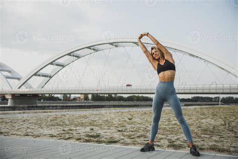 Fit Woman Stretching Her Arm While Working Up Outdoors Training