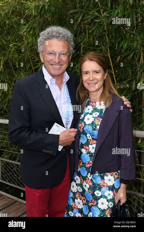 Nelson Montfort and his wife posing at the Village during French Tennis ...