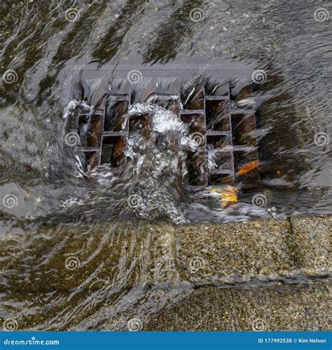 Heavy Rain Caused Flooding in Street, Water Swirling Around Storm Drain ...