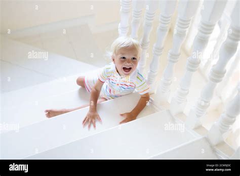 Kid Walking Stairs In White House Baby Boy Playing In Sunny Staircase