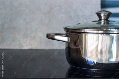 Big pot in modern kitchen with induction stove Stock Photo | Adobe Stock