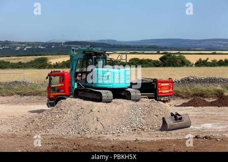 Jcb Excavator Digger Loading A Tipper Lorry With Earth From Basement