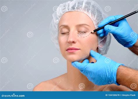 Plastic Surgery Doctor Drawing Perforation Lines On Woman S Face Stock