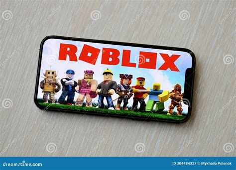 Roblox Mobile IOS Game on IPhone 15 Smartphone Screen on Wooden Table ...