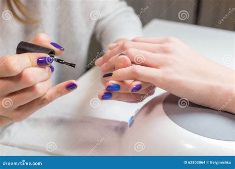 Beautician Paints Nails Woman Client In The Salon Stock Photo Image