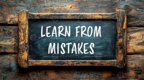 Learn from mistakes message written on black board with wooden