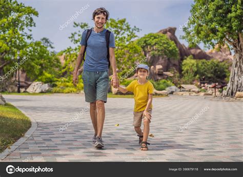 Happy Father And Son Walk In Nature Stock Photo By ©galitskaya 390679118