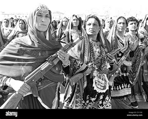 Afghan women village defense forces in traditional tribal costume carry ...