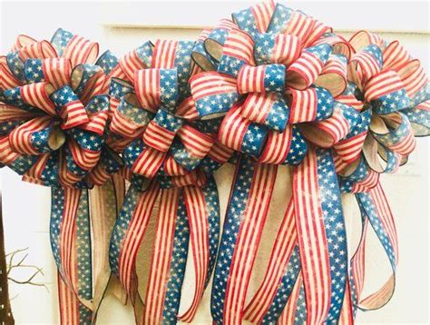 Red White And Blue Bows Hanging On The Side Of A Building In Front Of