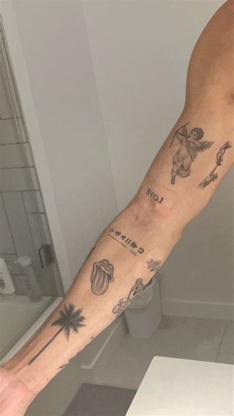 A Mans Arm With Tattoos On It