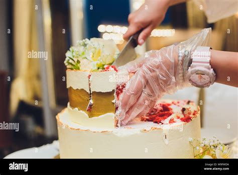 Three Tiered White Wedding Cake Decorated With Flowers From Mastic On A