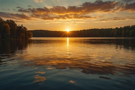 Premium Photo A Golden Sunrise Over A Tranquil Lake