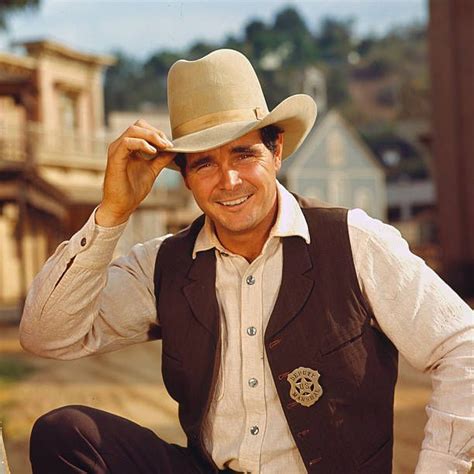 Promotional Portrait Of American Actor Buck Taylor As He Tips His Hat