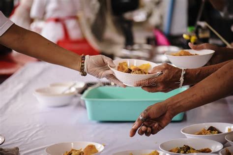 Volunteers Share Food To The Poor To Relieve Hunger Charity Concept