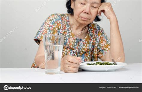 Elderly Asian Woman Bored With Food — Stock Photo © Toa55 158172092