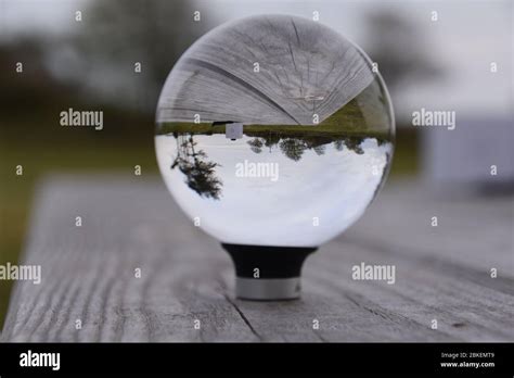 A Photograph Of An Original Lensball Pro 80mm K9 Crystal Ball On A Wooden Bench Table Stock