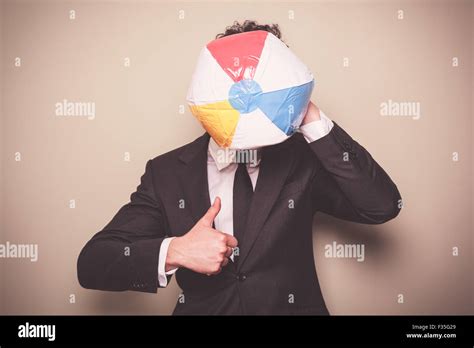 Blowing up a beach ball hi-res stock photography and images - Alamy