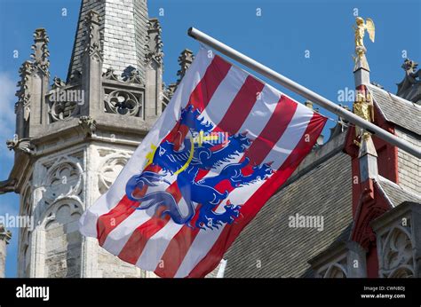 Flemish flag flying on a buttress of the Belfort in Bruges, Belgium ...