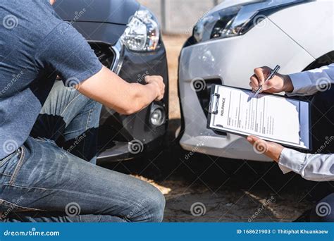 Insurance Agent Examining Car Crash And Customer Assessed Negotiation