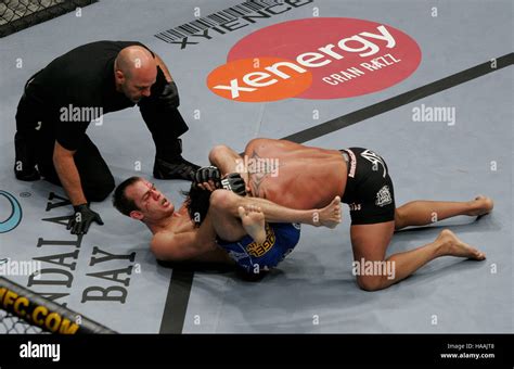 Cole Miller, left, applies a triangle choke to Jorge Gurgel during UFC ...