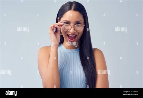 Oh Wow Cropped Portrait Of An Attractive Young Woman Peering Over Her Glasses While Standing