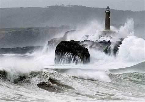 A Wave Hitting A Lighthouse Lighthouse Pretty Places Natural Landmarks