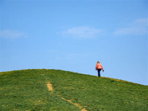 Woman Walking Up a Hill · Free Stock Photo