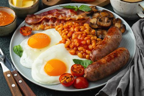 Full English Breakfast On A Plate With Fried Eggs Stock Photo By