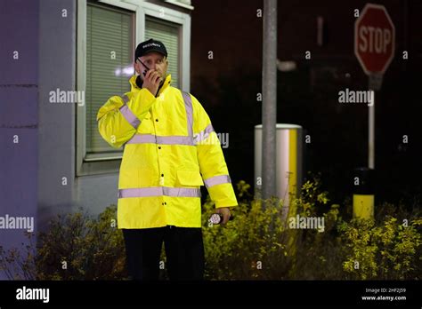 Security Guard At Entrance Gate At Night Stock Photo - Alamy